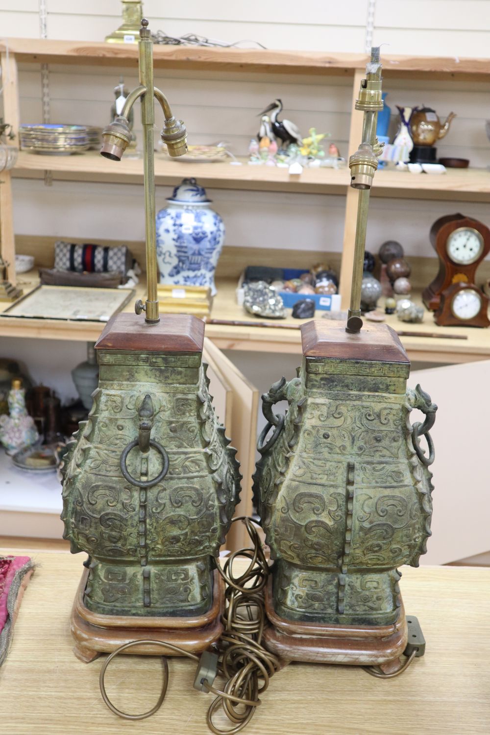 A pair of Chinese archaistic bronze lamps, height 47cm excl. light fitting